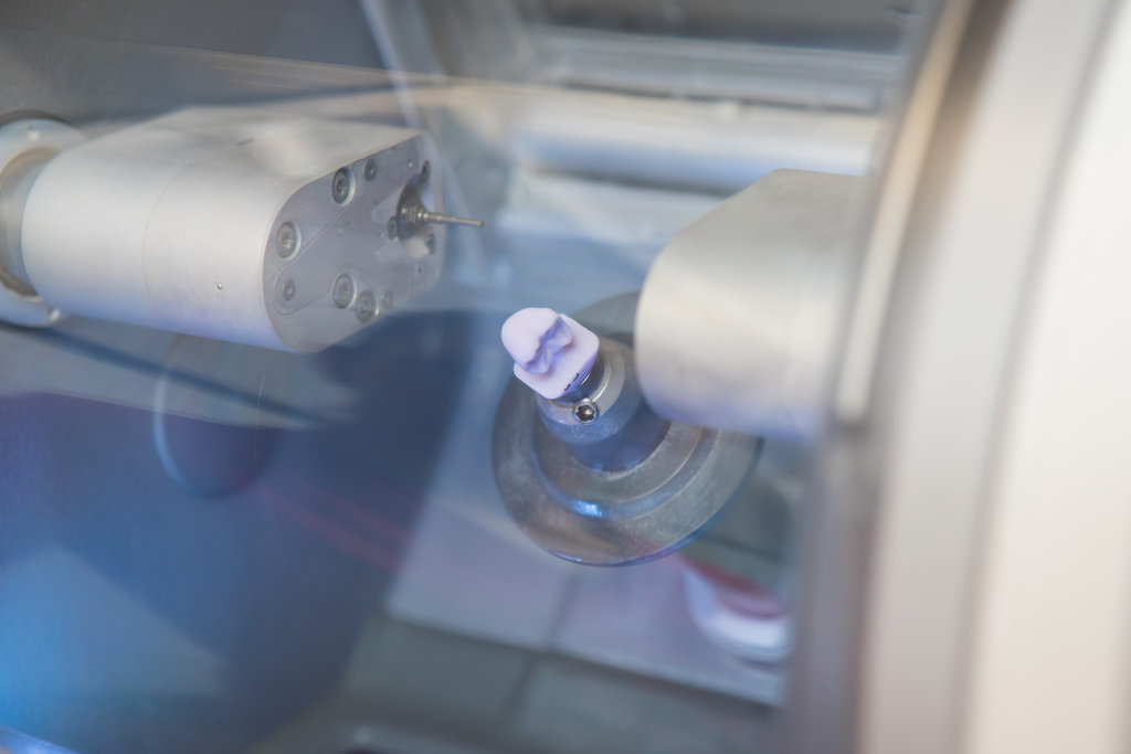 finished dental implant in the CEREC dental milling machine in the doctor's office