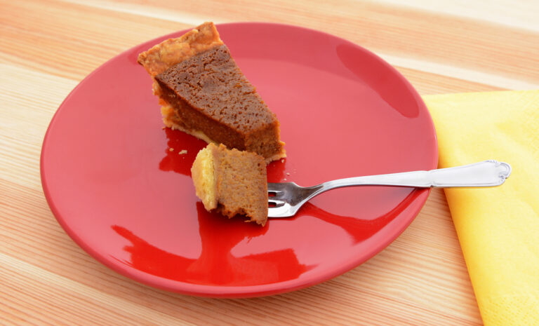 Bite of pumpkin pie on a fork